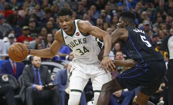 Milwaukee Bucks forward Giannis Antetokounmpo (34) passes the ball around Orlando Magic center Mo Bamba (5)